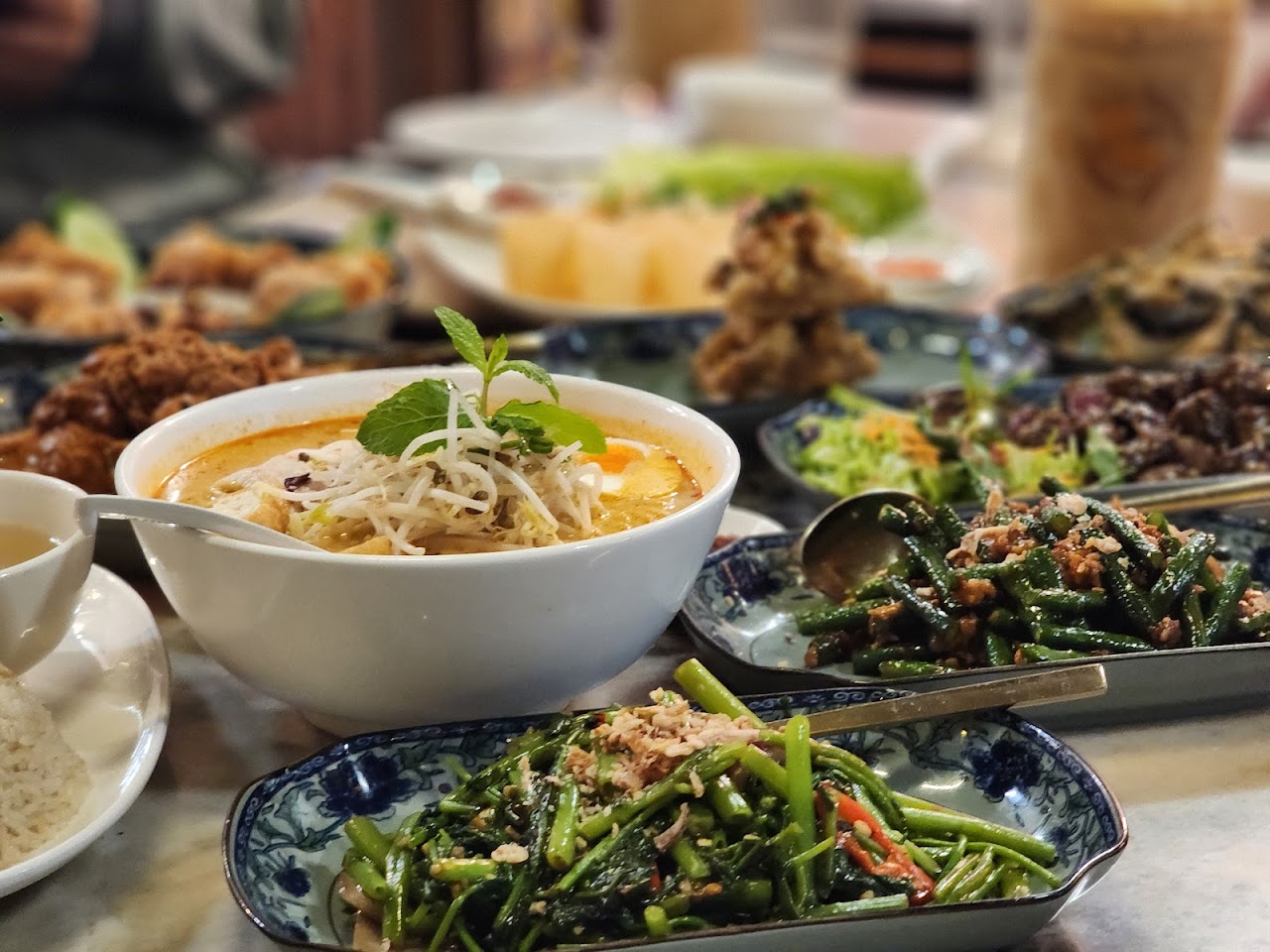 Ho Jiak table spread with laksa and vegetables