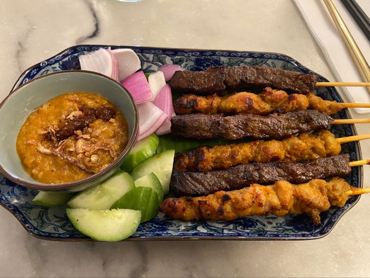 Satay skewers with peanut sauce and cucumber